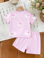 Girls' sweet pink short-sleeve top and shorts set featuring an all-over heart and cartoon idol print; a cute, casual, and versat